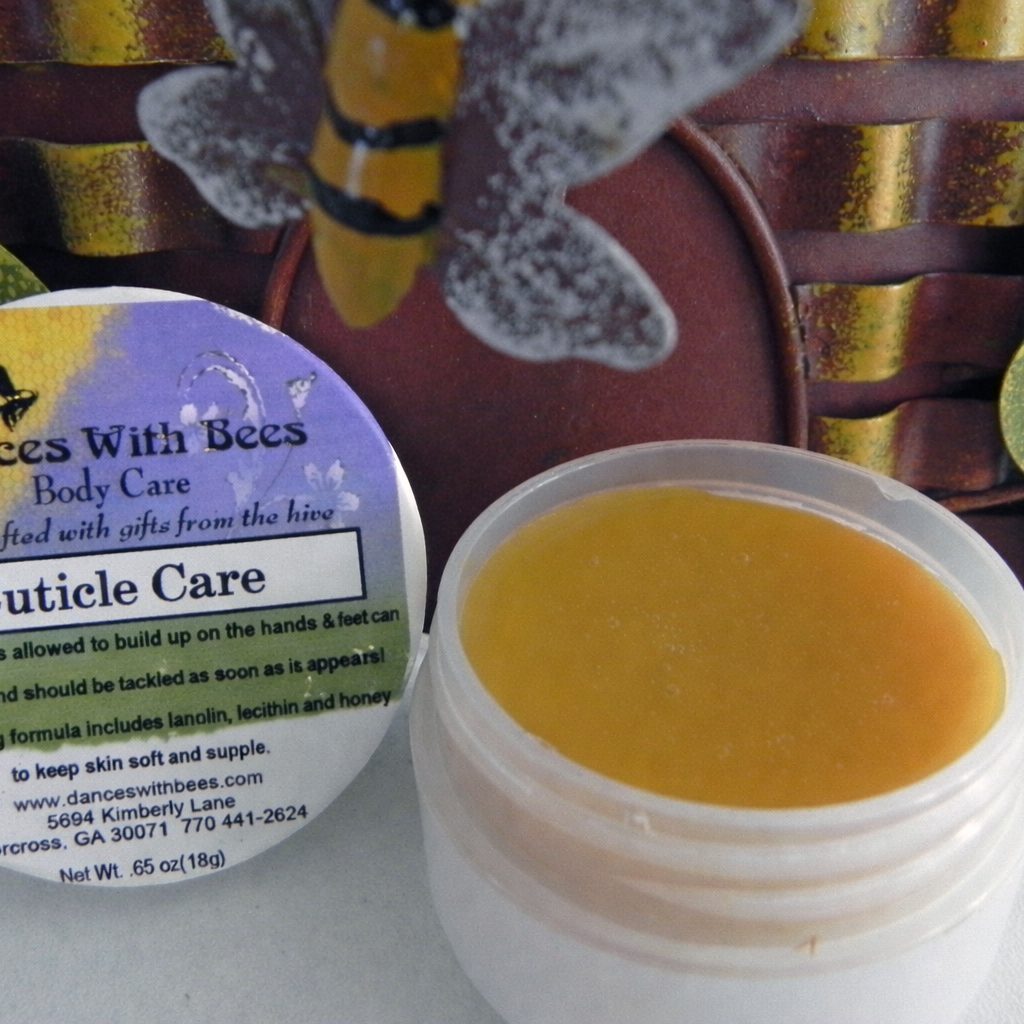 Dances With Bees cuticle care balm in a small container with decorative background.