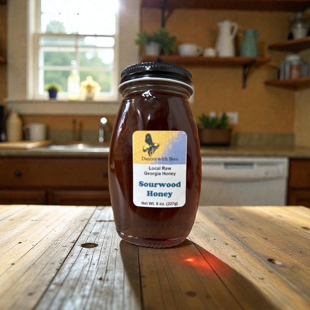 A jar of Sourwood Honey sits on a wooden kitchen table.
